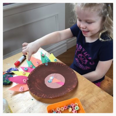 Paper plate turkey with loads of glitter glue and fruit loops. 