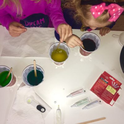 Making Rainbow slime.  Allowing the kids to be part of the process helps to grow their listening skills, sharing and confidence.  Check out the website for additional steps.  How2play.today