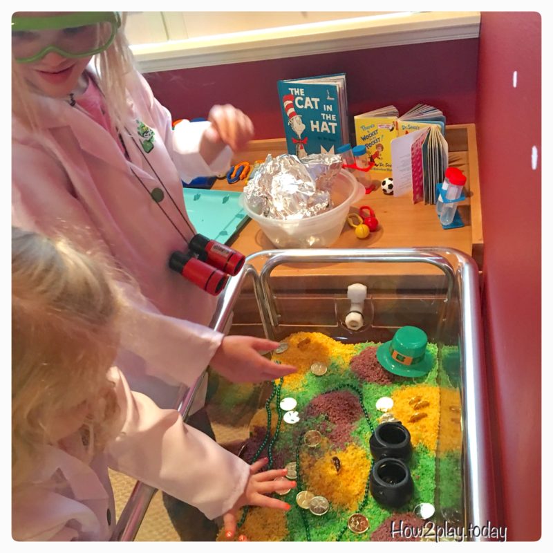 St. Patrick's Day sensory table complete with colored rice, gold coins and pots to fill. We added more items from our science center to complete this invitation to play.