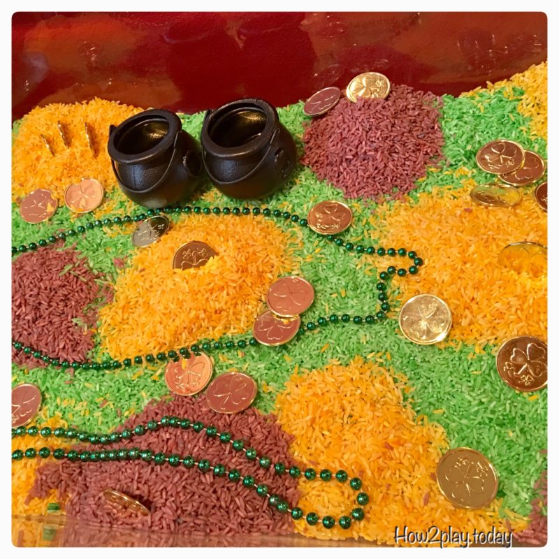 St. Patrick's Day sensory table complete with colored rice, gold coins and pots to fill. We added more items from our science center to complete this invitation to play.