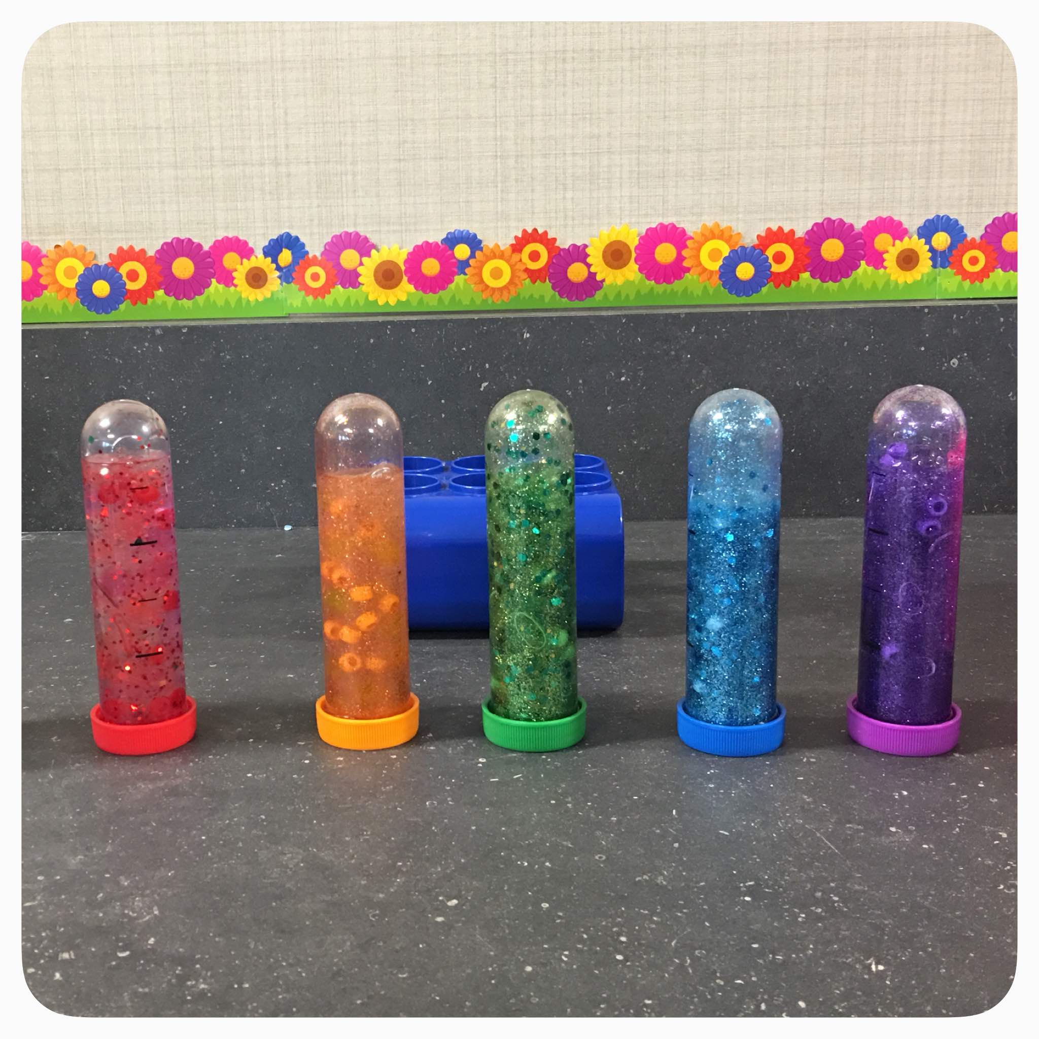 Rainbow Sensory Bottles: these calm down jars are mesmerizing and full of color. Great way sensory play activity for babies, to teach toddlers and preschools about colors, and to just enjoy seeing a rainbow every day.