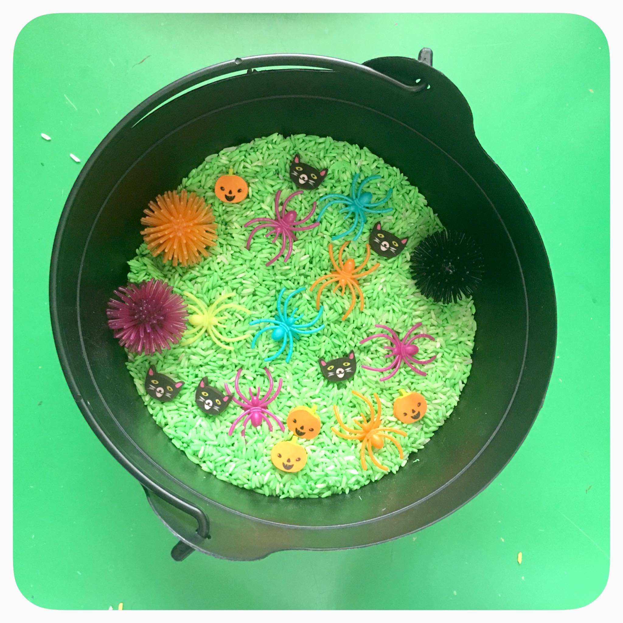 Halloween Cauldron sensory bin: created with non-toxic tempra paint and white rice. Add some fun and brightly colored spooky items and you've got yourself a fun halloween cauldron bin for your kids to enjoy for days.