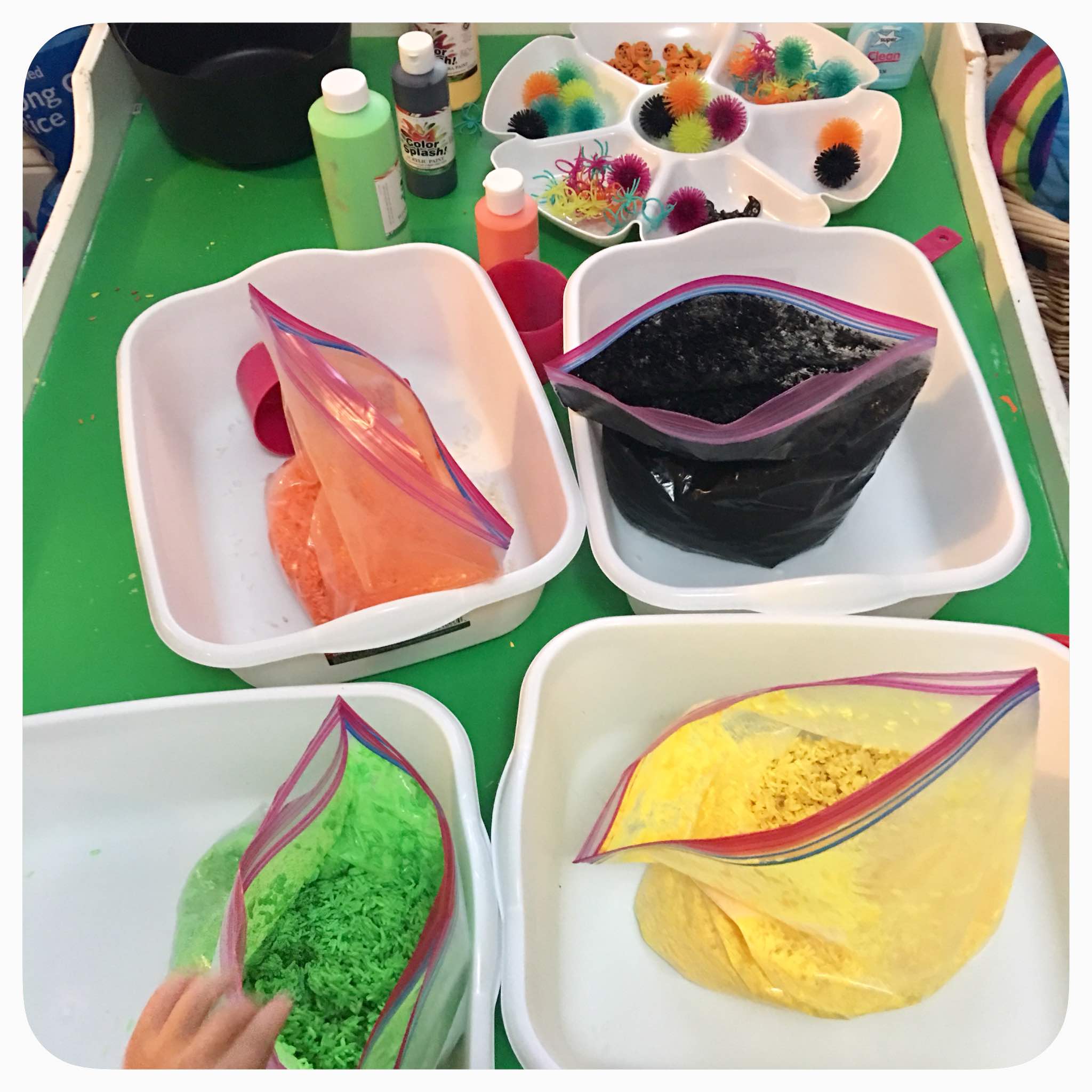 Halloween Cauldron sensory bin: created with non-toxic tempra paint and white rice. Add some fun and brightly colored spooky items and you've got yourself a fun halloween cauldron bin for your kids to enjoy for days.